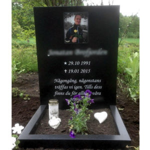 picture of installed peaceyard upright gravestone, model ada in night sky material with customer graphics