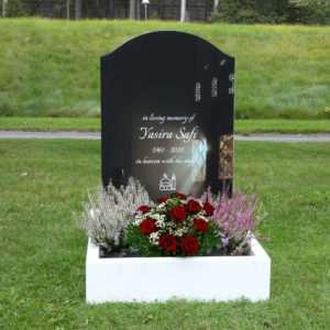 picture of installed peaceyard horizontal gravestone, model cora in glacier white color with customer graphics