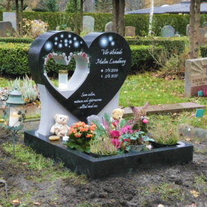 picture of installed peaceyard upright gravestone, custom model in night sky material with dove material inserts with customer graphics, integrated lantern and square planter