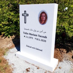 picture of installed peaceyard upright gravestone, Ada in glacier white material with customer graphics