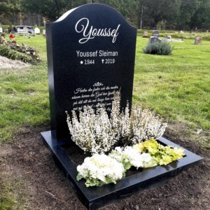 picture of installed peaceyard upright gravestone, Cora in night sky material with customer graphics